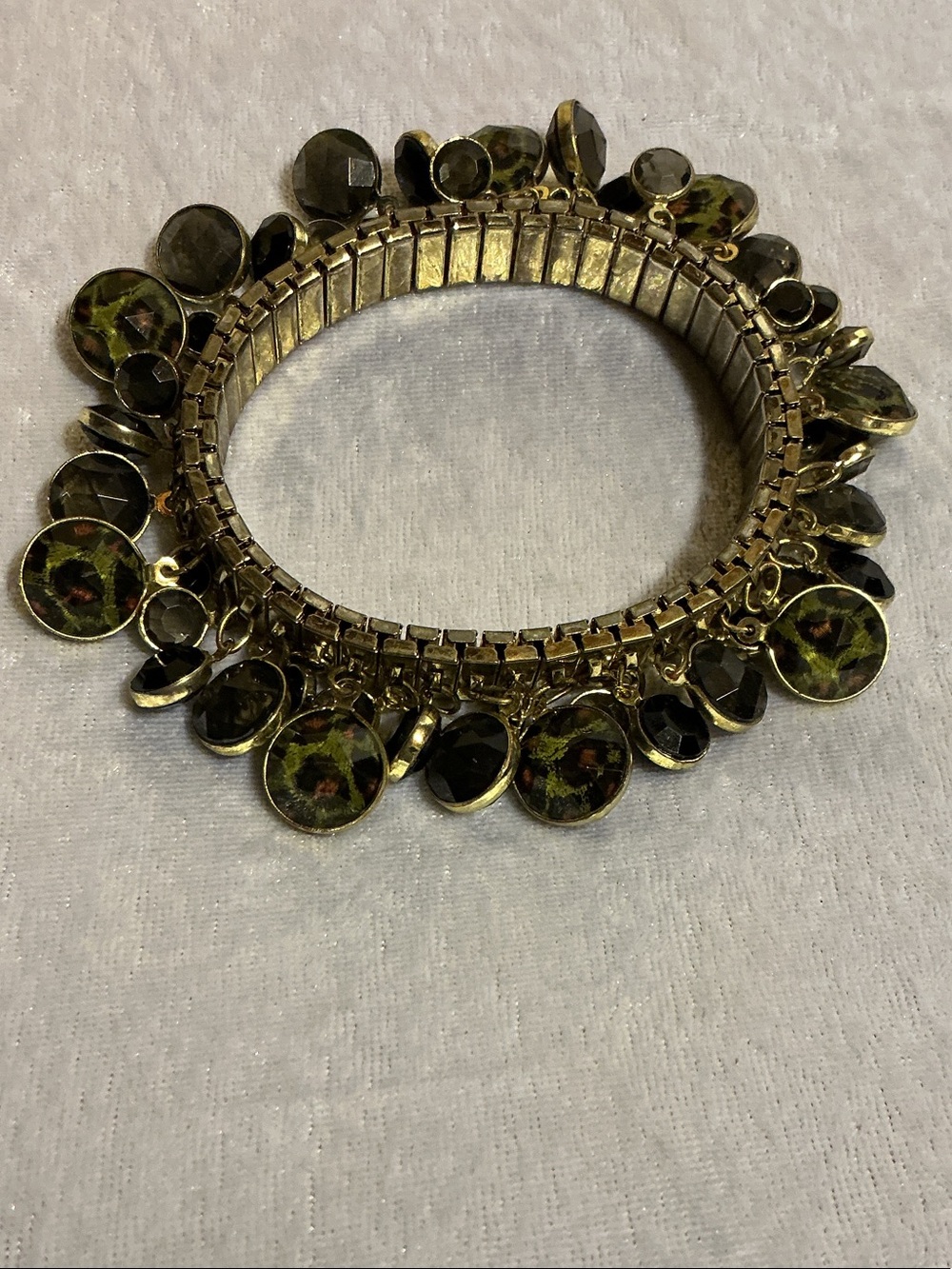 Gold Tone Stretch Bracelet with Black & Leopard Print Faceted Charms
